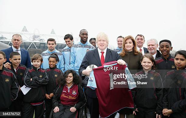 Boris Johnson the Mayor of London and players from West Ham pose for a picture during the press conference to announce the future of the Olympic...