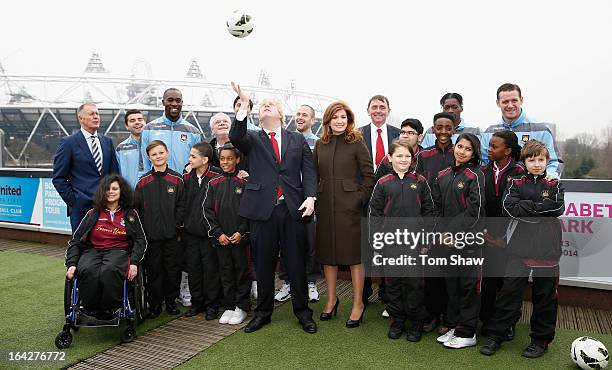 Boris Johnson the Mayor of London and players from West Ham pose for a picture during the press conference to announce the future of the Olympic...