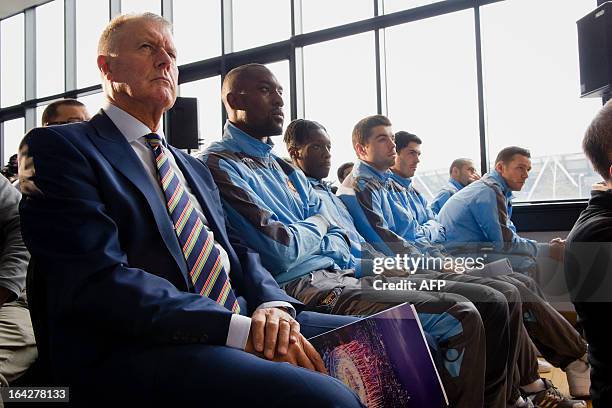 Former England footballer Geoff Hurst sits with members of the current West Ham squad during a press conference in east London to announce the new...