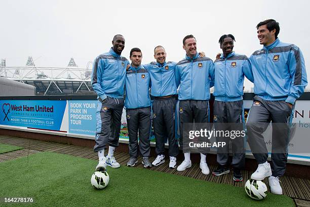 West Ham team players pose for photographers in front of the Olympic Stadium following a press conference in east London to announce the new deal...