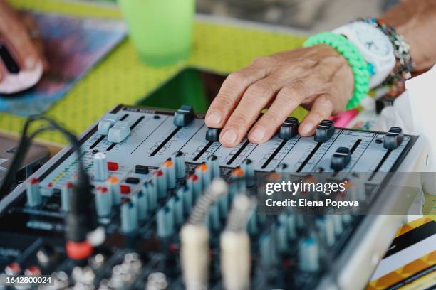 cropped hands senior woman working with sound mixer and doing dj set for outdoor summer party - old amplifier stock pictures, royalty-free photos & images