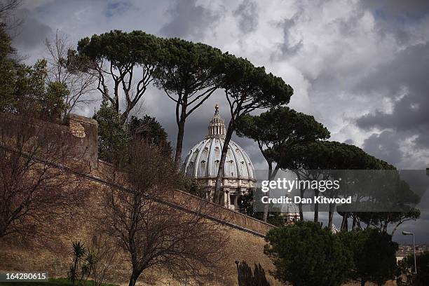 St Peter's Basilica is seen over the Vatican City wall on March 11, 2013 in Rome, Italy. Cardinals are set to enter the conclave to elect a successor...