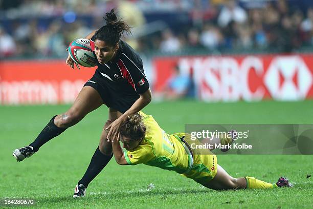 Magali Harvey of Canada is tackled during the Women's Cup final match between Australia and Canada on day one of the 2013 Hong Kong Sevens at Hong...