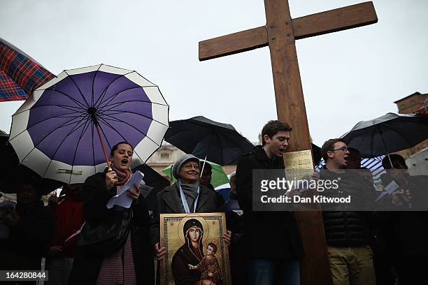 Pilgrims sing around a cross in St Peter's Square on March 13, 2013 in Vatican City, Vatican. Pope Benedict XVI's successor is being chosen by the...