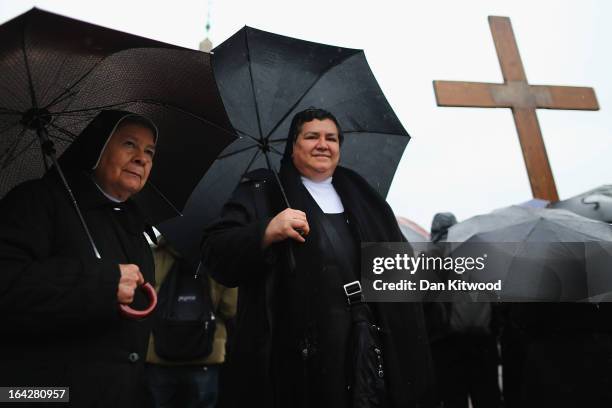 Nuns stand in heavy rain in St Peter's Square on March 13, 2013 in Vatican City, Vatican. Pope Benedict XVI's successor is being chosen by the...