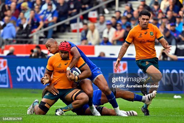 Langi Gleeson of Australia is tackled by Gael Fickou of France during the match between France and Australia at Stade de France on August 27, 2023 in...