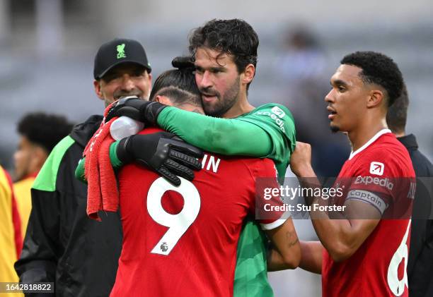 Liverpool head coach Jurgen Klopp celebrates with Darwin Nunez and goalkeeper Alisson Becker after the Premier League match between Newcastle United...