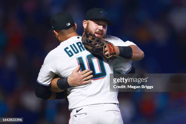 Yuli Gurriel and Jake Burger of the Miami Marlins embrace after defeating the Washington Nationals at loanDepot park on August 27, 2023 in Miami,...