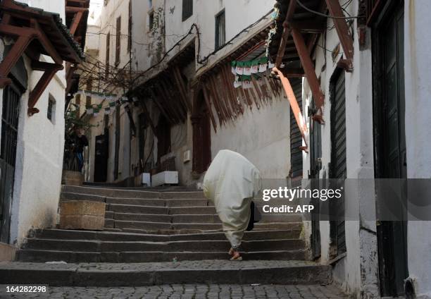 Woman climbs stairs in the Kasbah of Algiers on March 22, 2013 in Algeria. The Kasbah is a Unesco World Heritage site. AFP PHOTO FAROUK BATICHE