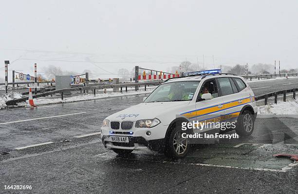 Police car is seen on patrol as heavy snowfall causes the closure of the A66 on March 22, 2013 in Bowes, United Kingdom. Heavy snow is causing...