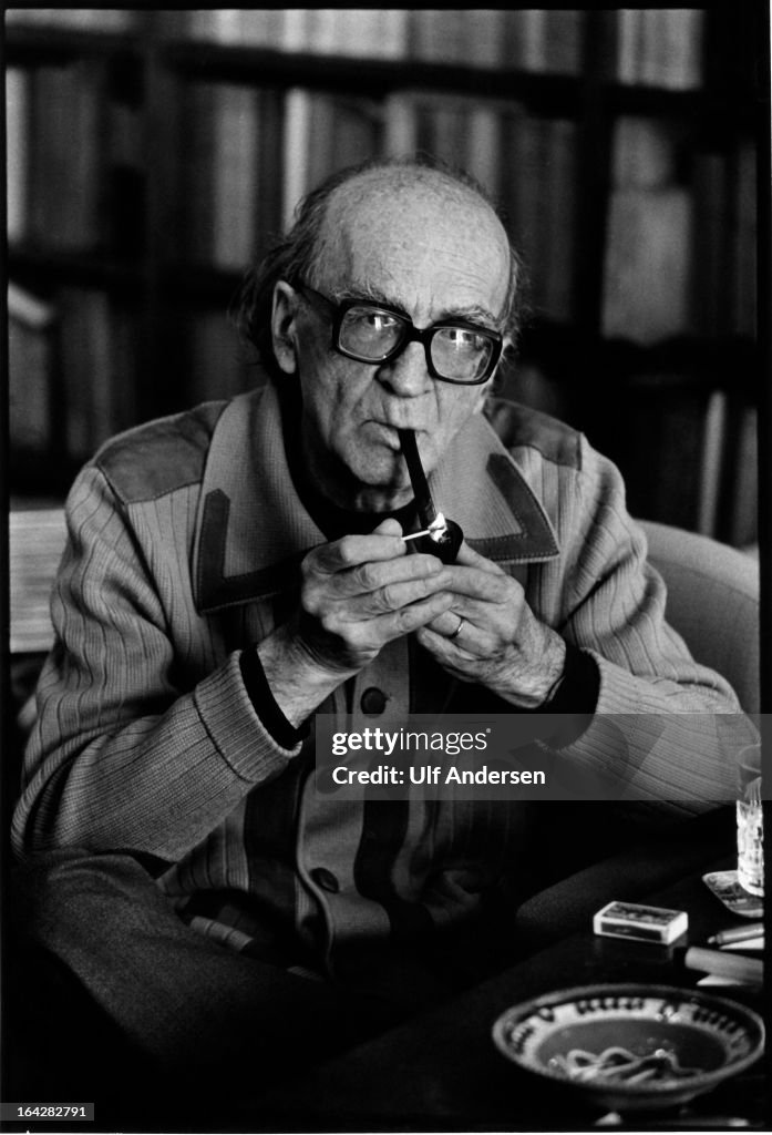 Romanian writer and essayist Mircea Eliade at home during a