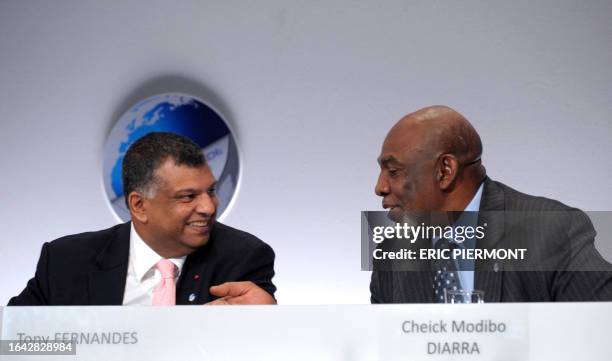 Malaysian budget carrier AirAsia chief Executive Tony Fernandes talks with Microsoft Corporation President for Africa Cheick Modibo Diarra while...