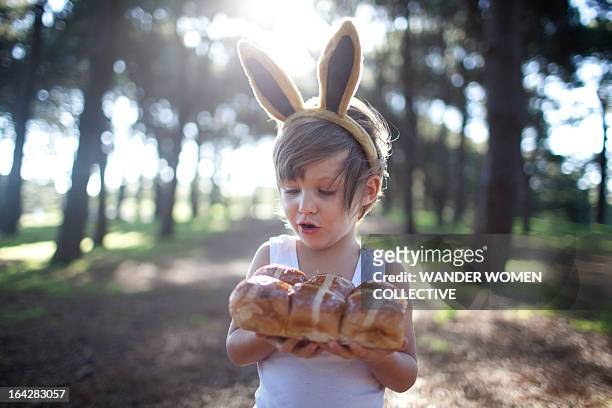 boy in forest  bunny ears with hot cross buns - bunny ears stockfoto's en -beelden