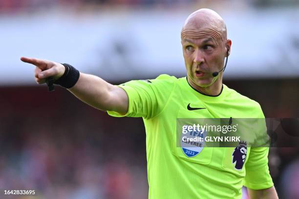 English referee Anthony Taylor gestures during the English Premier League football match between Arsenal and Manchester United at the Emirates...