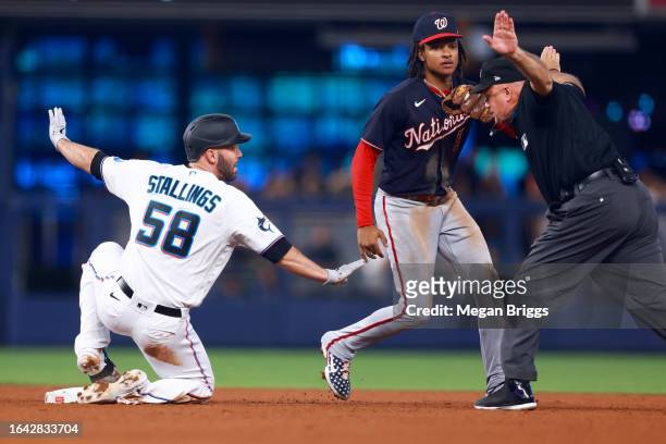 Jacob Stallings of the Miami Marlins slides safe to second base against the Washington Nationals during the fourth inning of the game at loanDepot...