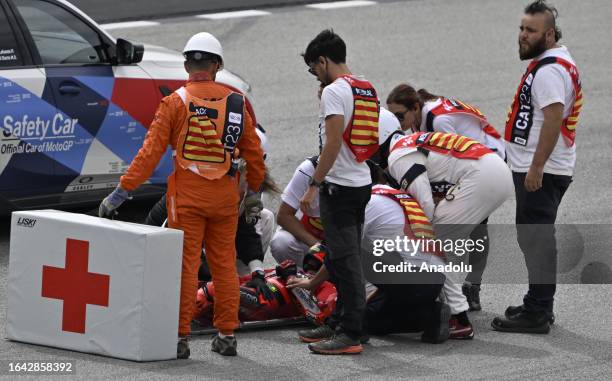 Francesco Bagnaia of Ducati Lenovo is taken into an ambulance on a stretcher by track marshals after a crash during the Catalunya Moto Grand Prix at...