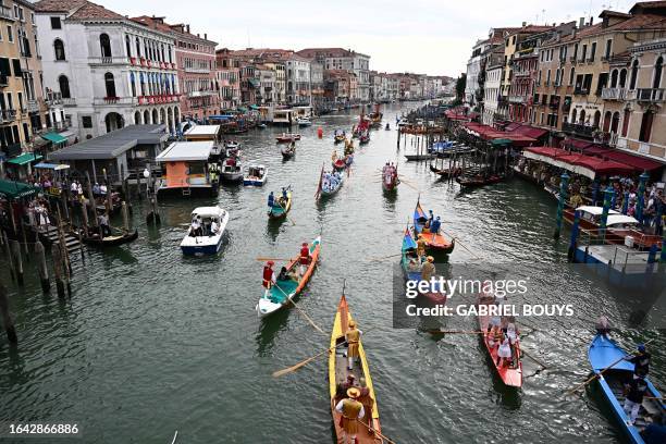 Rowers take part in the annual gondolas and boats Historical Regatta on the Grand Canal in Venice on September 3, 2023.