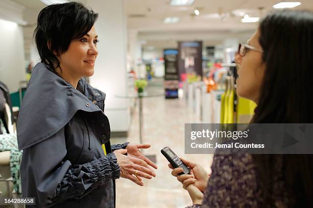 Members of the media speak with designer Michelle Franklin during an in-store visit to the Lord & Taylor Flagship store on March 22, 2013 in New York...