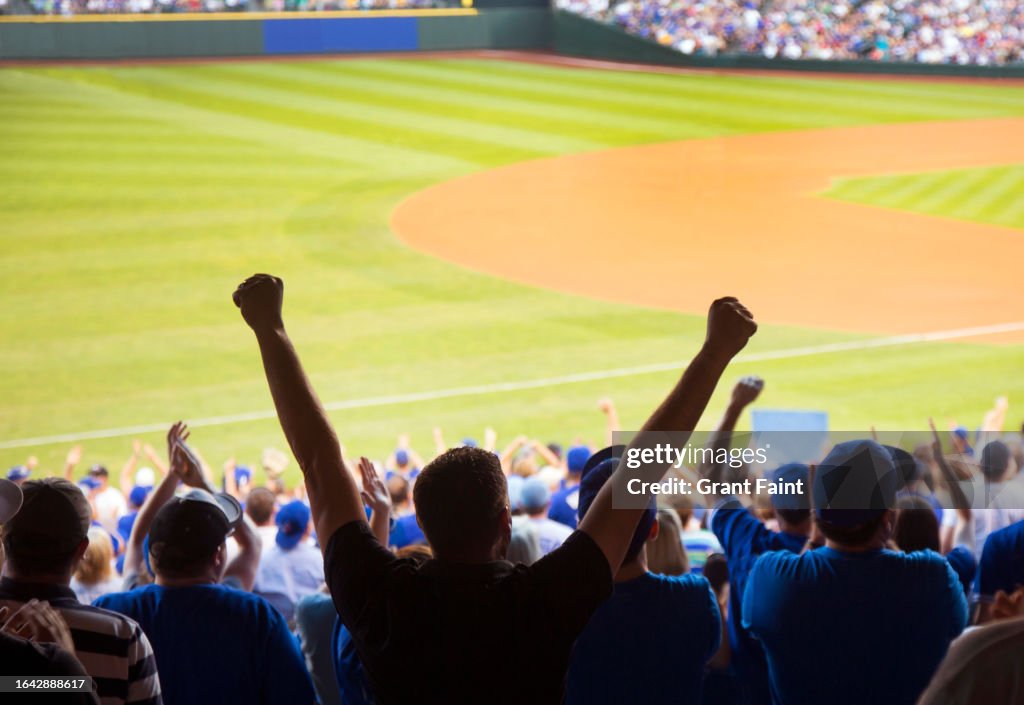 Baseball fans celebrating.
