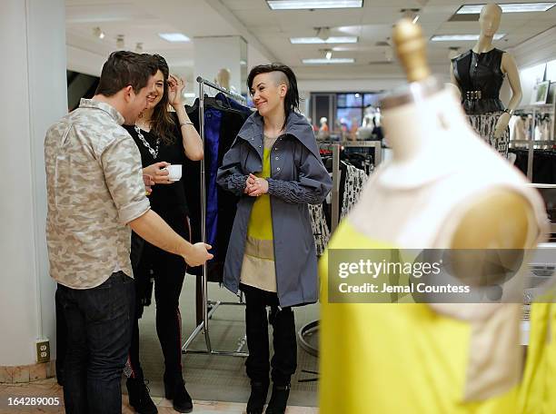 Writers Adam Mamsuroglu and Catherine Peridis of Cosmopolitan speak with designer Michelle Franklin during an in-store visit to the Lord & Taylor...