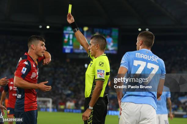 The referee Livio Marinelli shows the yellow card to Ruslan Malinovskyi of Genoa CFC during the Serie A TIM match between SS Lazio and Genoa CFC at...