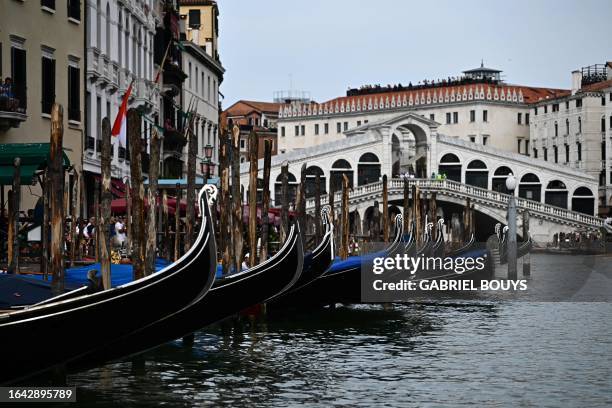 Gondolas are docked near Rialto bridge on the Grand Canal in Venice on September 3, 2023.