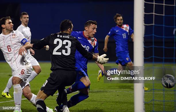Croatia's forward Ivica Olic scores a goal despite Serbia's goalkeeper Zelijko Brkic during the World Cup 2014 qualifying football match Croatia vs...