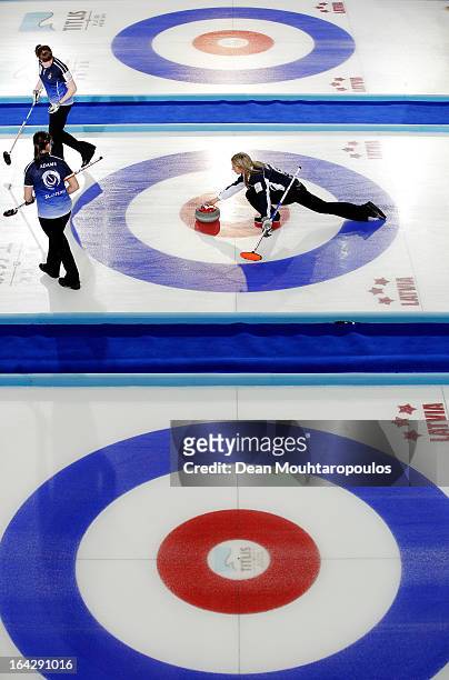 Eve Muirhead of Scotland throws a stone as Vicki Adams and Claire Hamilton get ready to sweep in the match between Scotland and Sweden on Day 7 of...