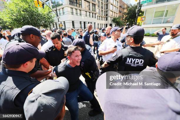 Counter protestor is arrested after a confrontation with anti-migrant protestors during arally and protest outside of Gracie Mansion on August 27,...