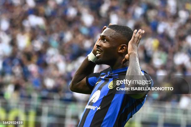 Inter Milan's French forward Marcus Thuram celebrates scoring his team's first goal during the Italian Serie A football match between Inter Milan and...