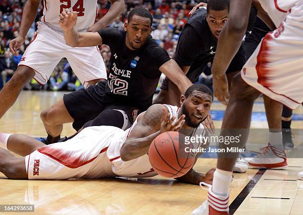 Richard Howell of the North Carolina State Wolfpack tries to pass a loose ball against Rahlir Hollis-Jefferson of the Temple Owls in the second half...