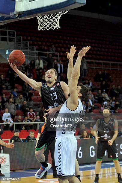 Montepaschi Siena's Viktor Sanikidze goes to basket and vies with Besiktas JK's Cemal Nalga during the Euroleague Top 16 basketball match between...