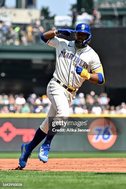 Teoscar Hernandez of the Seattle Mariners gestures after hitting a solo home run during the first inning against the Kansas City Royals at T-Mobile...