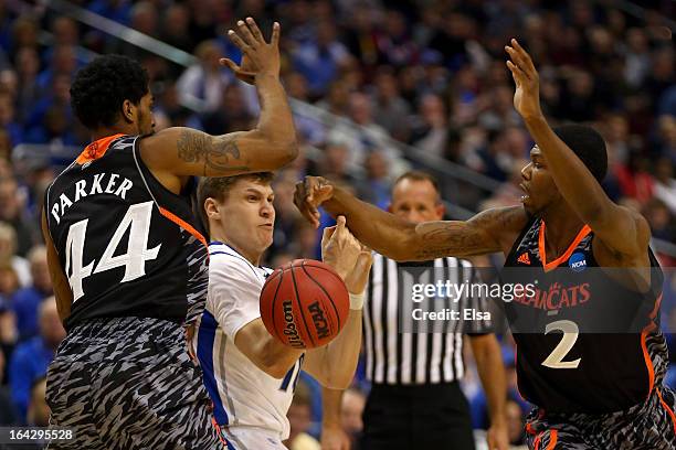 Grant Gibbs of the Creighton Bluejays loses the ball between JaQuon Parker and Titus Rubles of the Cincinnati Bearcats in the first half during the...