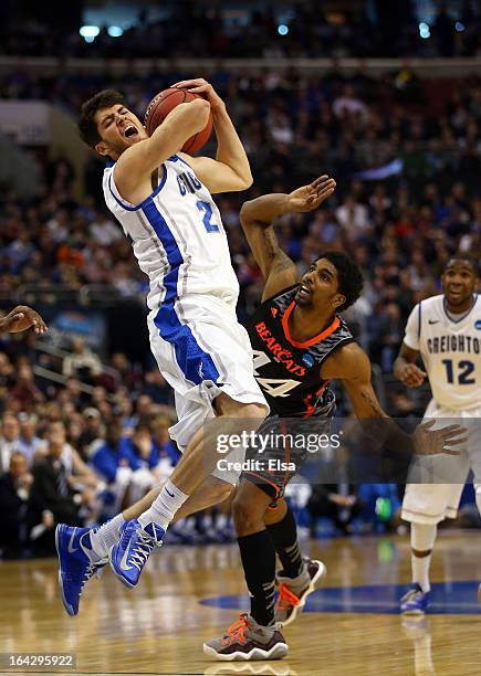 Avery Dingman of the Creighton Bluejays is fouled by JaQuon Parker of the Cincinnati Bearcats in the first half during the second round of the 2013...