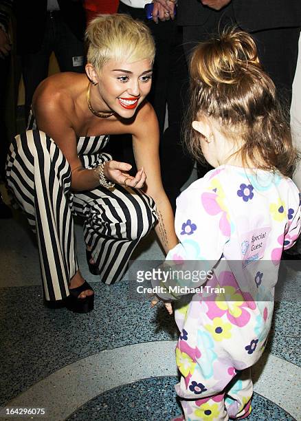 Miley Cyrus and a young patient from CHOC's Childrens Hospital attend The Ryan Seacrest Foundation West Coast debut of new multi-media broadcast...