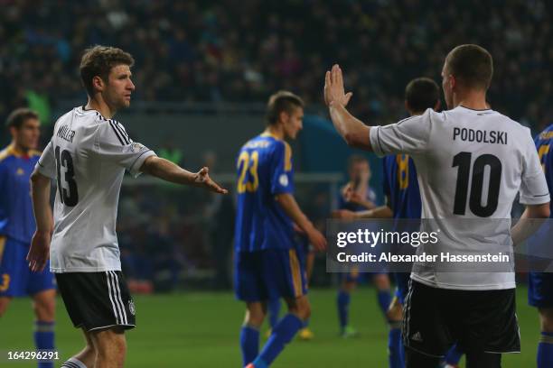 Thomas Mueller of Germany celebrates scoring the 4th team goal with his team mate Lukas Podolski during the FIFA 2014 World Cup qualifier group C...