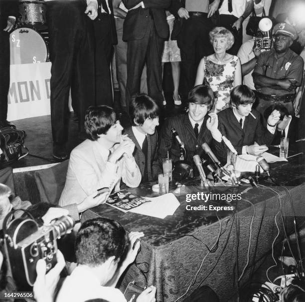 English pop group The Beatles giving a press conference at the Hollywood Bowl, Los Angeles, California, 23rd August 1964. Left to right: Paul...