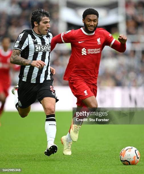 Newcastle player Sandro Tonali outpaces Joe Gomez during the Premier League match between Newcastle United and Liverpool FC at St. James Park on...