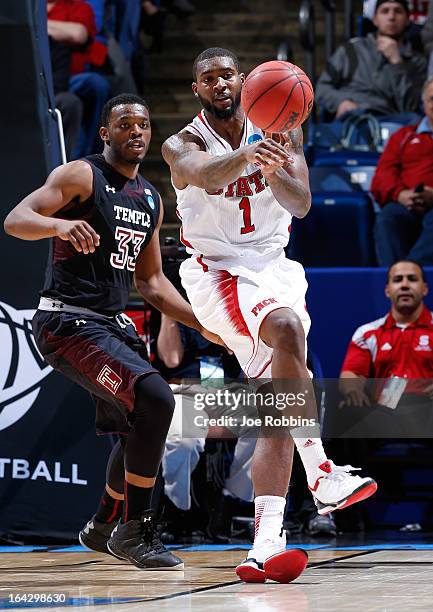 Richard Howell of the North Carolina State Wolfpack passes the ball against Scootie Randall of the Temple Owls in the second half during the second...