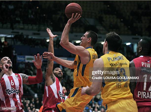 Olympiakos Piraeus Josh Powell and Pero Antic try to stop Maccabi Tel Aviv Nik Caner during their Euroleague top 16 match at the Peace and Friendship...