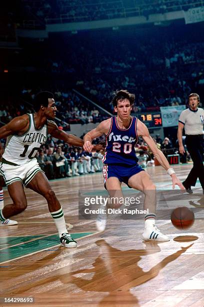 Doug Collins of the Philadelphia 76ers dribbles the ball against the Boston Celtics during a game played circa 1976 at the Boston Garden in Boston,...