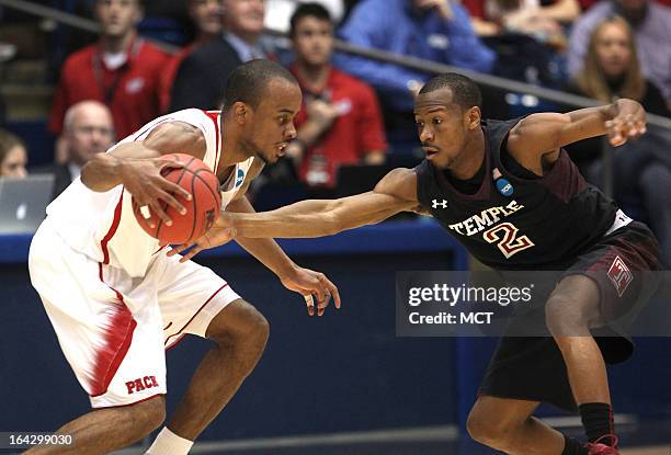 Temple Owls guard Will Cummings reaches for the ball as North Carolina State Wolfpack guard Lorenzo Brown dribbles during the first half of the East...