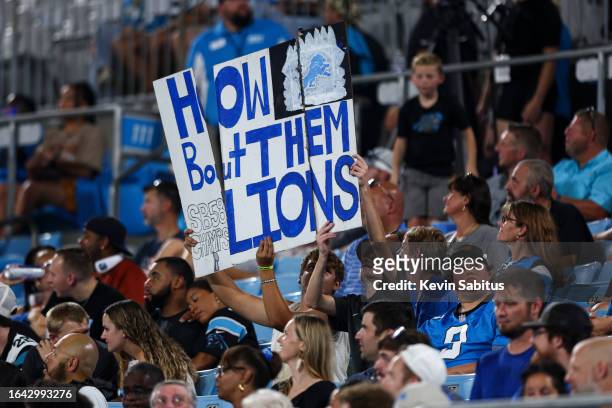 Detroit Lions fans hold a sign during an NFL preseason football game against the Carolina Panthers at Bank of America Stadium on August 25, 2023 in...
