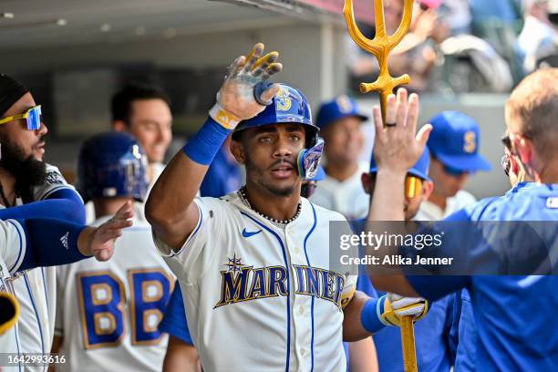 Julio Rodriguez of the Seattle Mariners celebrates with teammates after hitting a two-run home run during the fifth inning against the Kansas City...