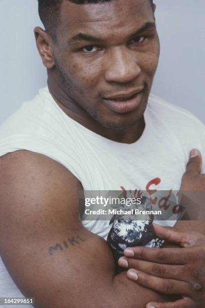 American heavyweight boxer Mike Tyson with one of his pet homing pigeons in Catskill, New York State, 1985.