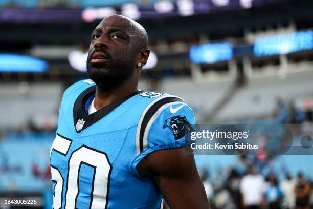 Justin Houston of the Carolina Panthers stretches prior to an NFL preseason football game against the Detroit Lions at Bank of America Stadium on...