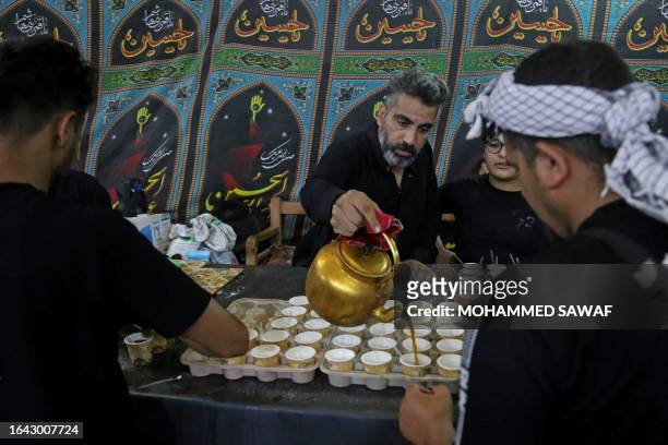 Man pours coffee for Shiite Muslim pilgrims in the Iraqi shrine city of Karbala on September 3 ahead of the Arbaeen religious festival commemorating...