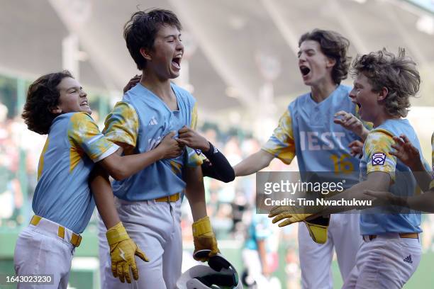Louis Lappe of the West Region team from El Segundo, California celebrates with teammates after hitting a walk-off home run to defeat the Caribbean...