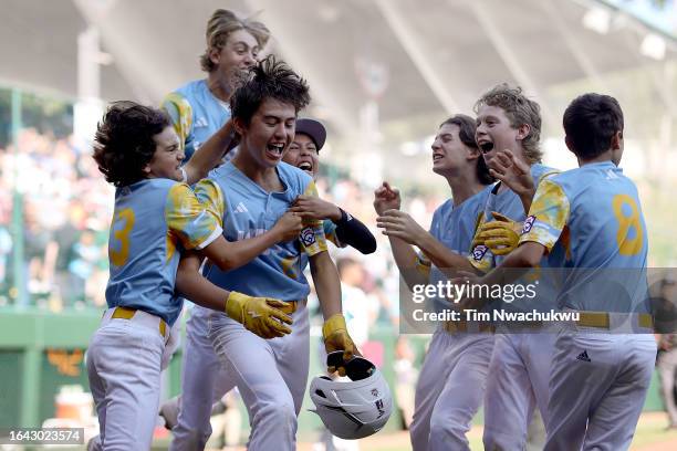 Louis Lappe of the West Region team from El Segundo, California celebrates with teammates after hitting a walk-off home run to defeat the Caribbean...
